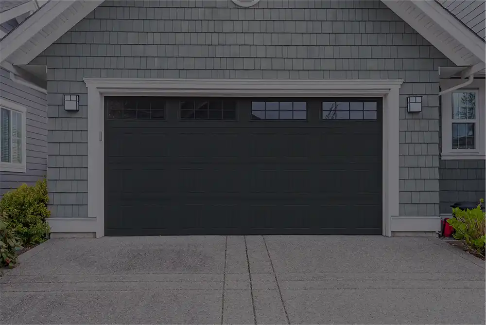 A photo of a residential garage door that has just been fixed by a garage door repair company.